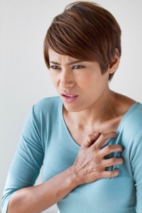sick woman with sudden heart attack symptom